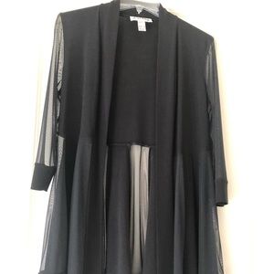 Black top with sheer inserts, long sleeve.